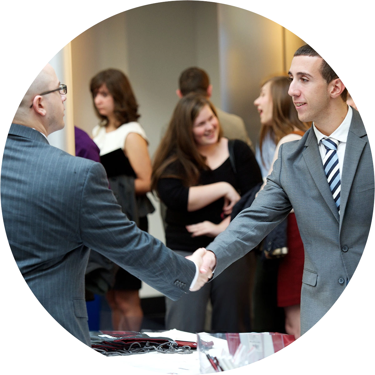 College of Business MS Student networking at an event with business professionals