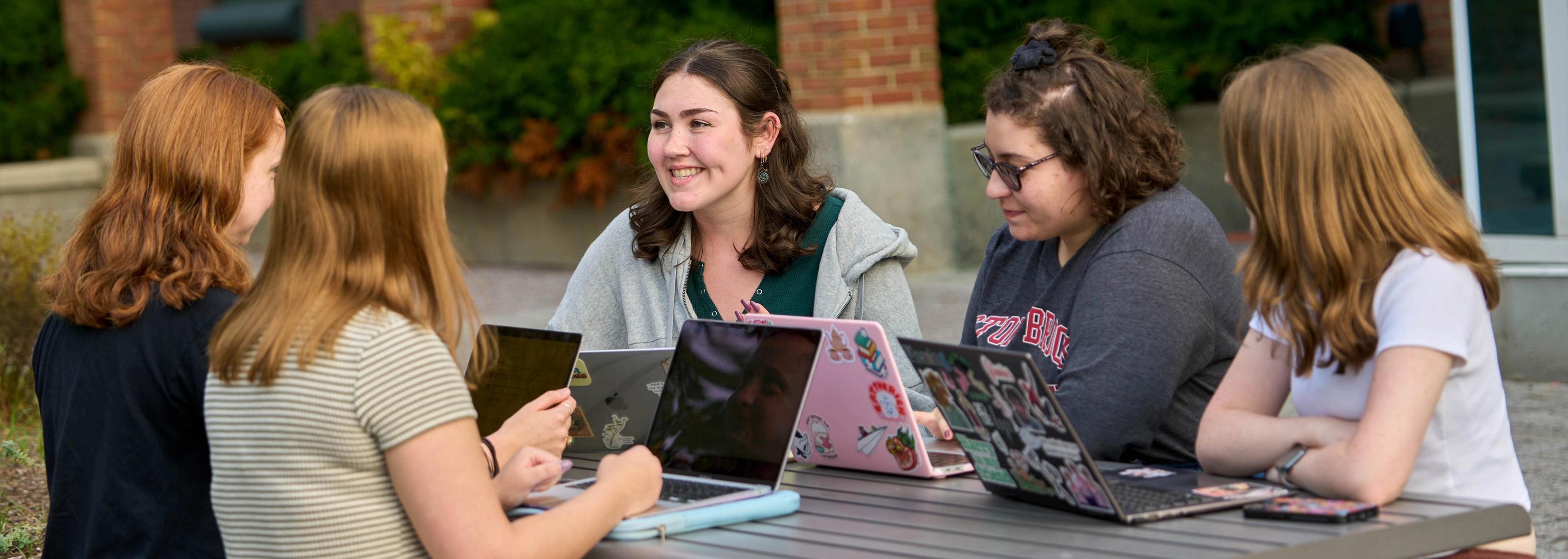 SUNY Stony Brook University College of Business MBA STudents attending an event sitting at a table in conversation