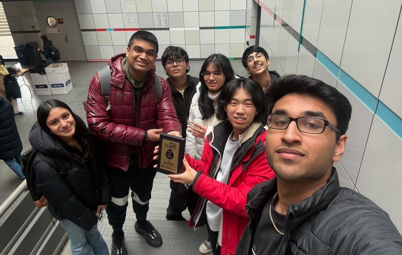 A selfie of the ICPS team that competed in Zero Robotics. They are holding a plaque that says "third place"