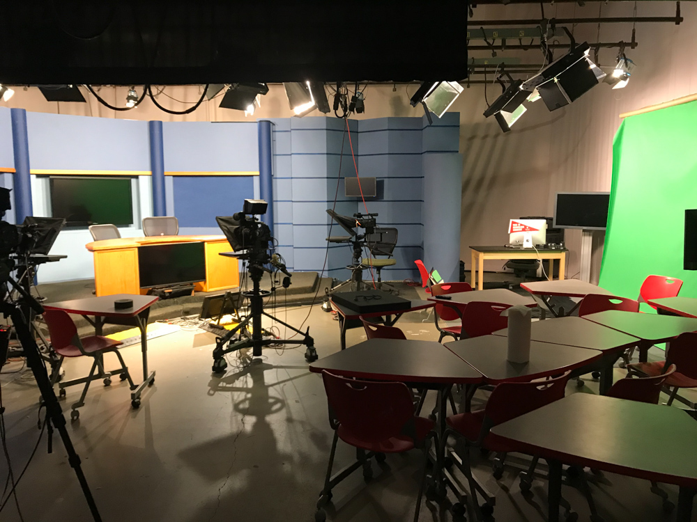 Empty broadcast studio with cameras, green screen and chairs 