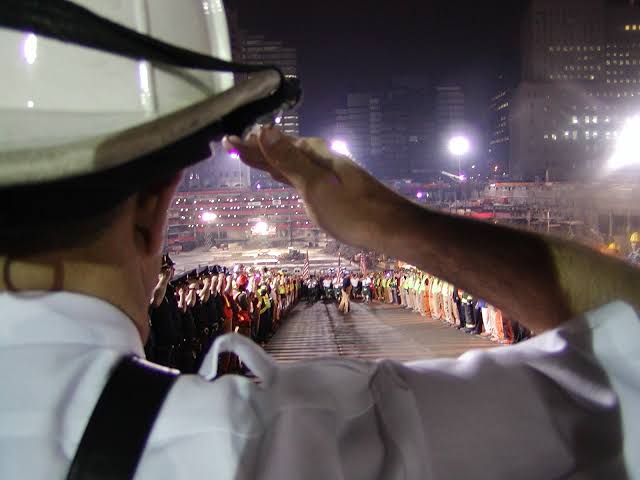 A man saluting nine eleven survivors.